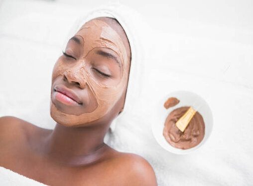Pretty woman enjoying a chocolate facial treatment at the health spa